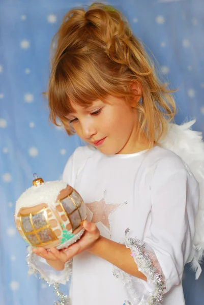 Angel girl holding christmas ball in hand — Stock Photo, Image
