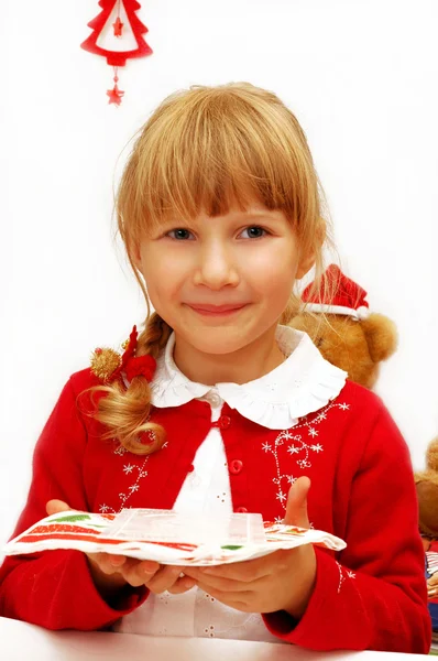 Little girl with christmas eve wafer on plate — Stock Photo, Image