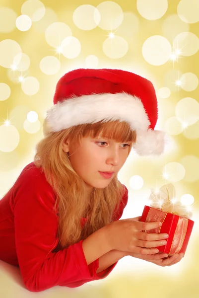 Girl with christmas gift on shining background — Stock Photo, Image