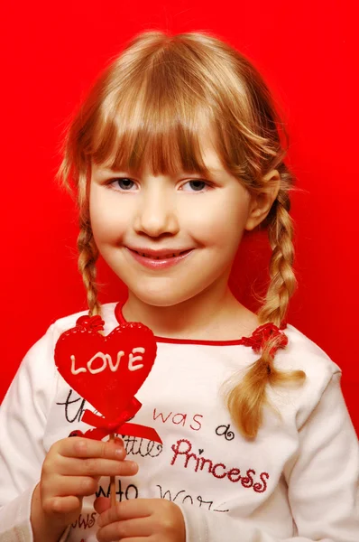 心脏的形状棒棒糖的小女孩 — 图库照片