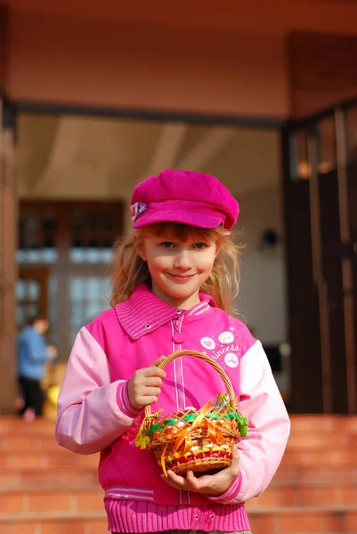 Little girl in front of church in easter time — Stock Photo, Image