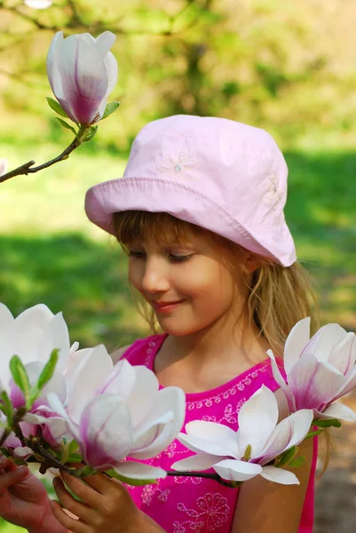 Young girl with magnolia — Stock Photo, Image