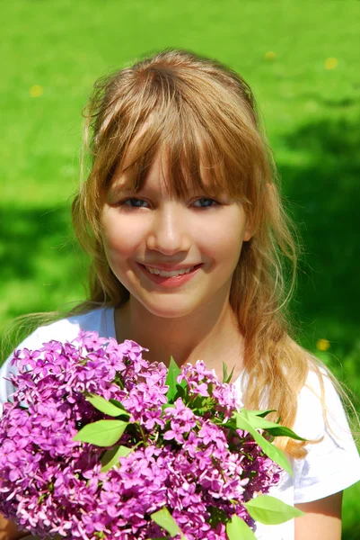 Young girl with bunch of lilac — Stock Photo, Image