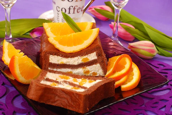 Chocolate cake with cream and oranges — Stock Photo, Image