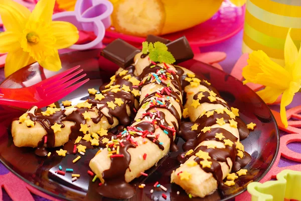 Bananas with chocolate and sprinkles for child — Stock Photo, Image