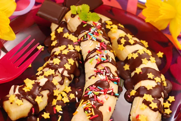 Bananas with chocolate and sprinkles for child — Stock Photo, Image