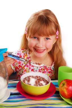 Girl eating chocolate cornflakes clipart