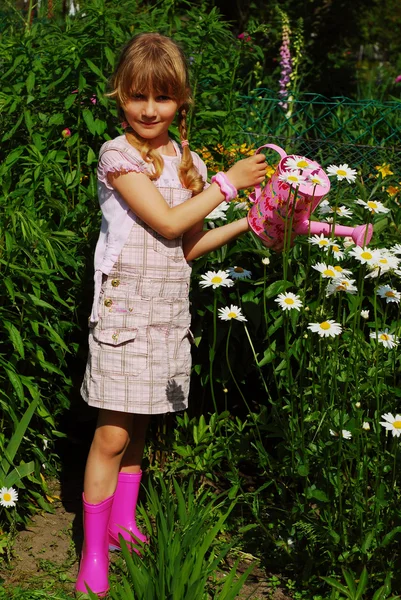 Young girl in the garden with watering can — Stock Photo, Image