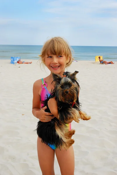 Girl with yorkshire dog on the beach — Stok fotoğraf