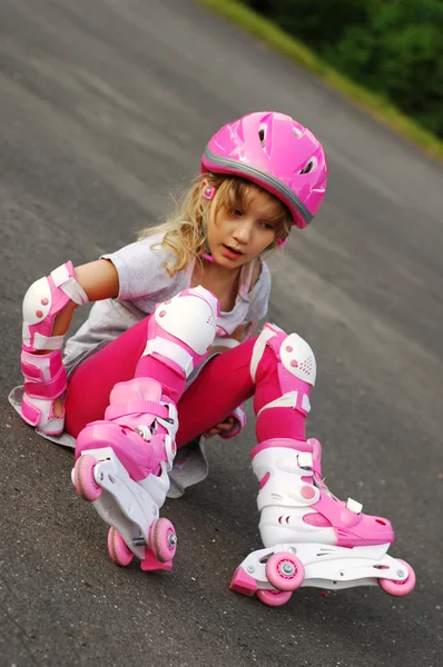 Young girl rollerskating-falling down — Stock Photo, Image