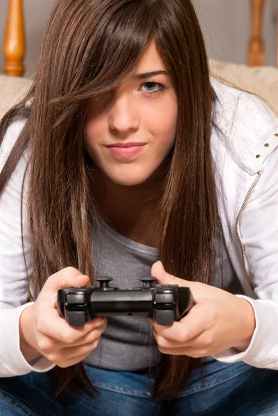 stock image Young female concentrating playing videogames close-up on sofa at home