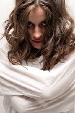 Young insane woman with straitjacket looking at camera close-up portrait clipart