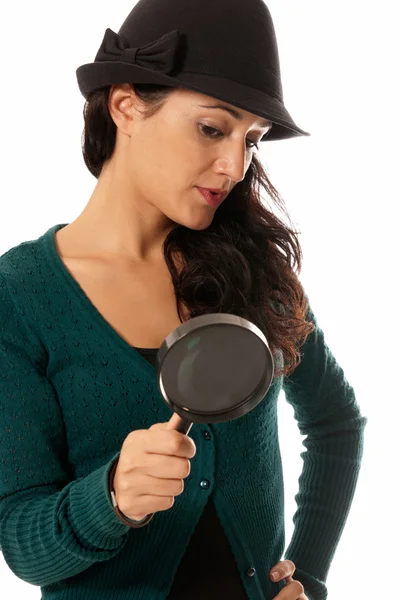 Young woman with magnifier glass and hat looking for something isolated on — Stock Photo, Image