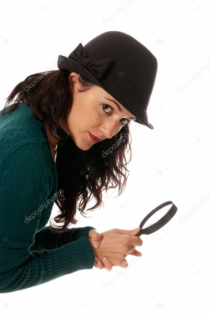 Young woman with magnifier glass and hat looking to camera isolated on whit