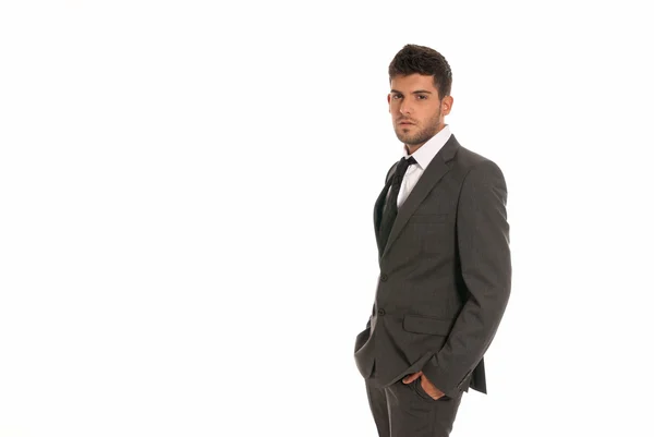 Young businessman with copy-space looking serious hands in pockets isolated — Stock Photo, Image