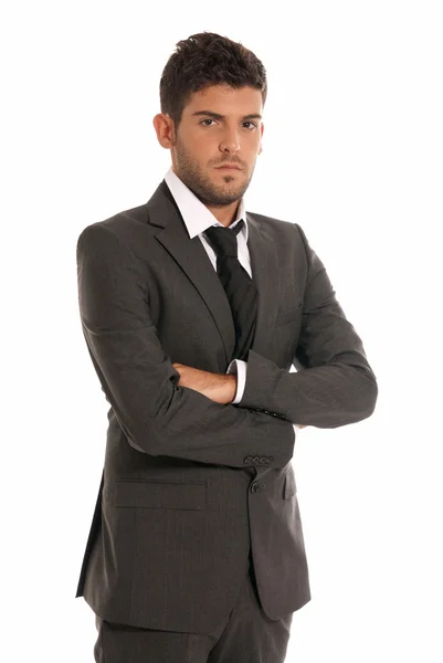 Giovane uomo d'affari guardando gravi braccia incrociate isolato su sfondo bianco — Foto Stock