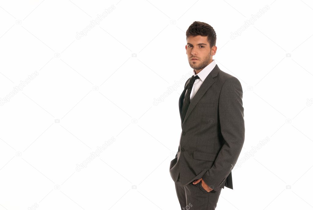 Young businessman with copy-space looking serious hands in pockets isolated