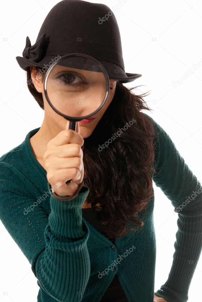 Young woman looking through magnifying glass loupe detective isolated on wh