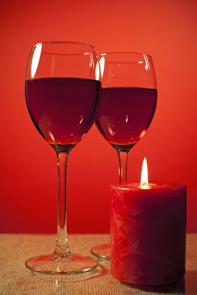 Glass of wine and a candle — Stock Photo, Image