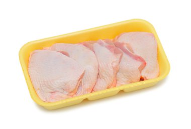 Frozen chicken in a plastic tray, isolated on a white background clipart