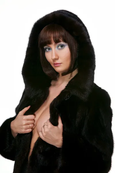 The sexy girl in a fur coat on a white background — Stock Photo, Image