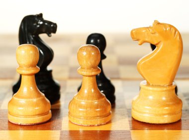 Figures on a chessboard clipart