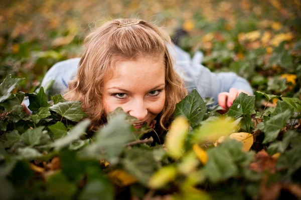 Young caucasian student girl in golden autumn park — Stock Photo, Image