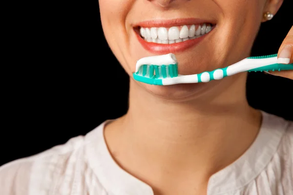 Жінка здорові зуби крупним планом з зубною щіткою на чорному тлі — стокове фото