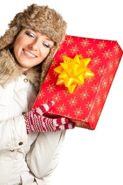 stock image Caucasian blond woman in furry hat and christmas gifts isolated on white