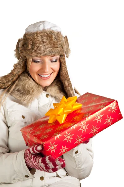 stock image Caucasian blond woman in furry hat and christmas gifts isolated on white