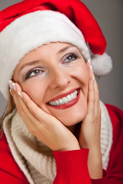 Woman in santa hat with christmas presents Stock Picture