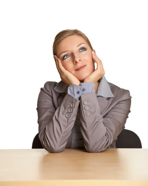 Kvinna i kostym som sitter vid skrivbordet isolerad på vit — Stockfoto