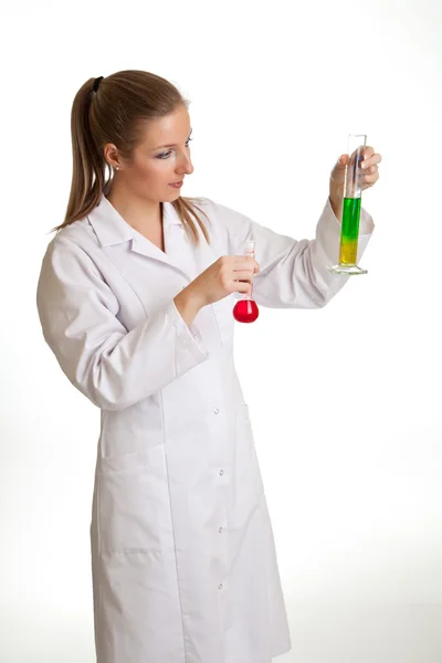 Isolated scientist woman in lab coat with chemical glassware — Stock Photo, Image