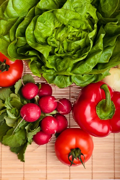 stock image Different ripe vegetables compositions in studio laying on bamboo plate