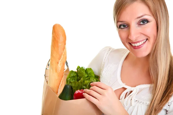 Woman carrying bag of groceries isolated on white — Stock Photo, Image