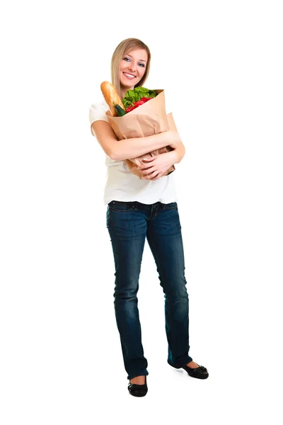 Woman carrying bag of groceries isolated on white — Stock Photo, Image