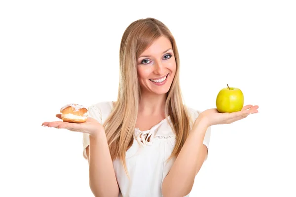 Woman choosing apple over puff cookie isolated on white — Stock Photo, Image