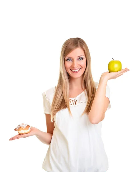 Woman choosing apple over puff cookie isolated on white — Stock Photo, Image