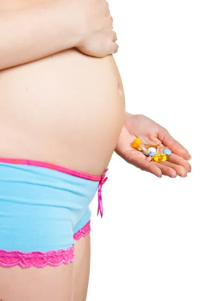 Pregnant woman holding pharmaceutical drugs — Stock Photo, Image