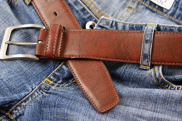 Blue jeans and a brown leather belt. — Stock Photo, Image