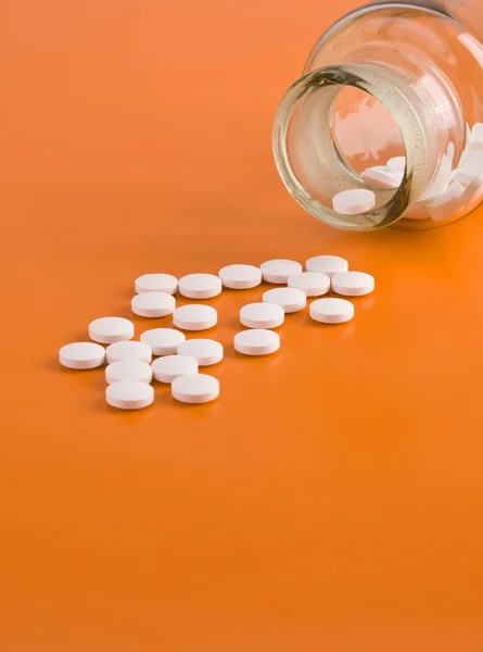 Pills on orange background — Stock Photo, Image