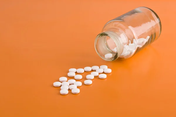 Pills spilled from a bottle — Stock Photo, Image