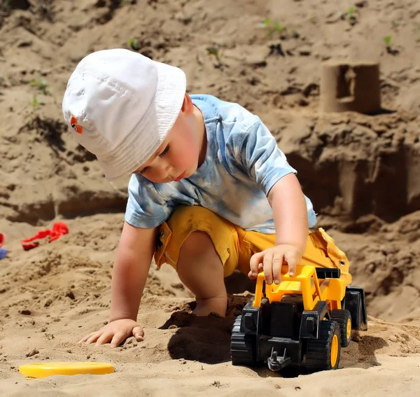 Маленький ребенок играет с песком — стоковое фото