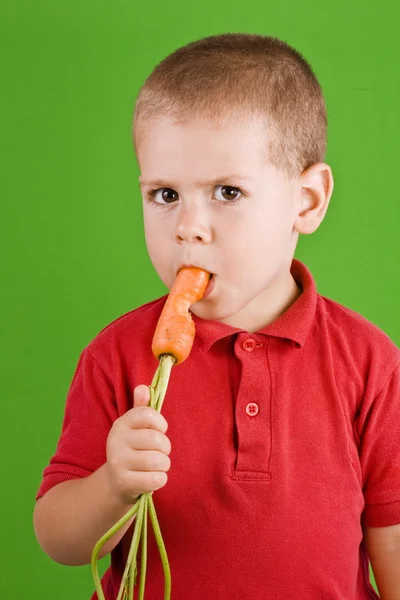 Boy and carrot — Stock Photo, Image