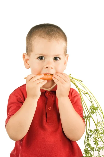 Boy and carrots — Stock Photo, Image
