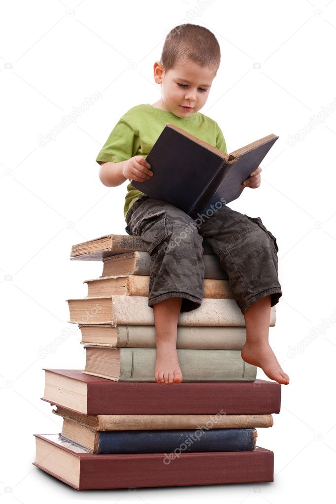 Boy sitting on a big pile of books.