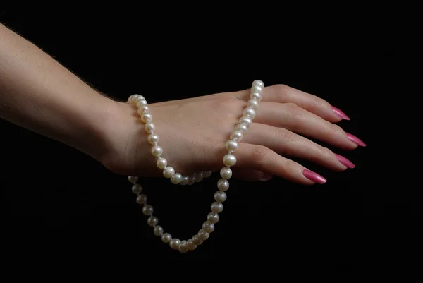 Hand with pearl beads Royalty Free Stock Photos