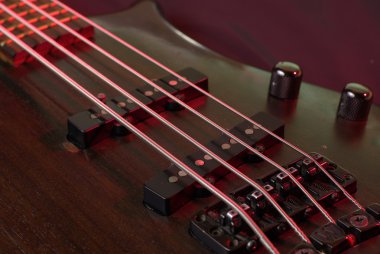 Closeup of a guitar on the black background clipart