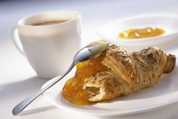 Almendras croissant y mermelada de albaricoque Imagen de stock