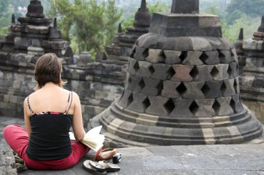 Tourist sketching borobudur temple indonesia clipart